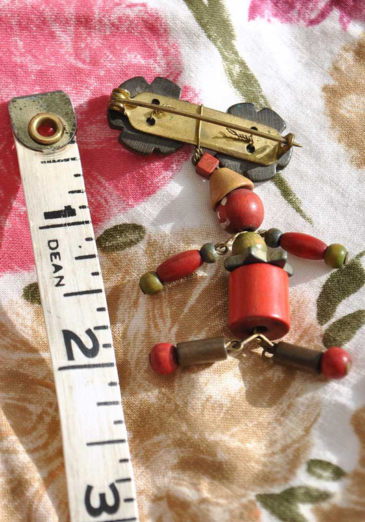 1940s Dyed Wooden Articulated Man Bead Brooch • Haskell Era