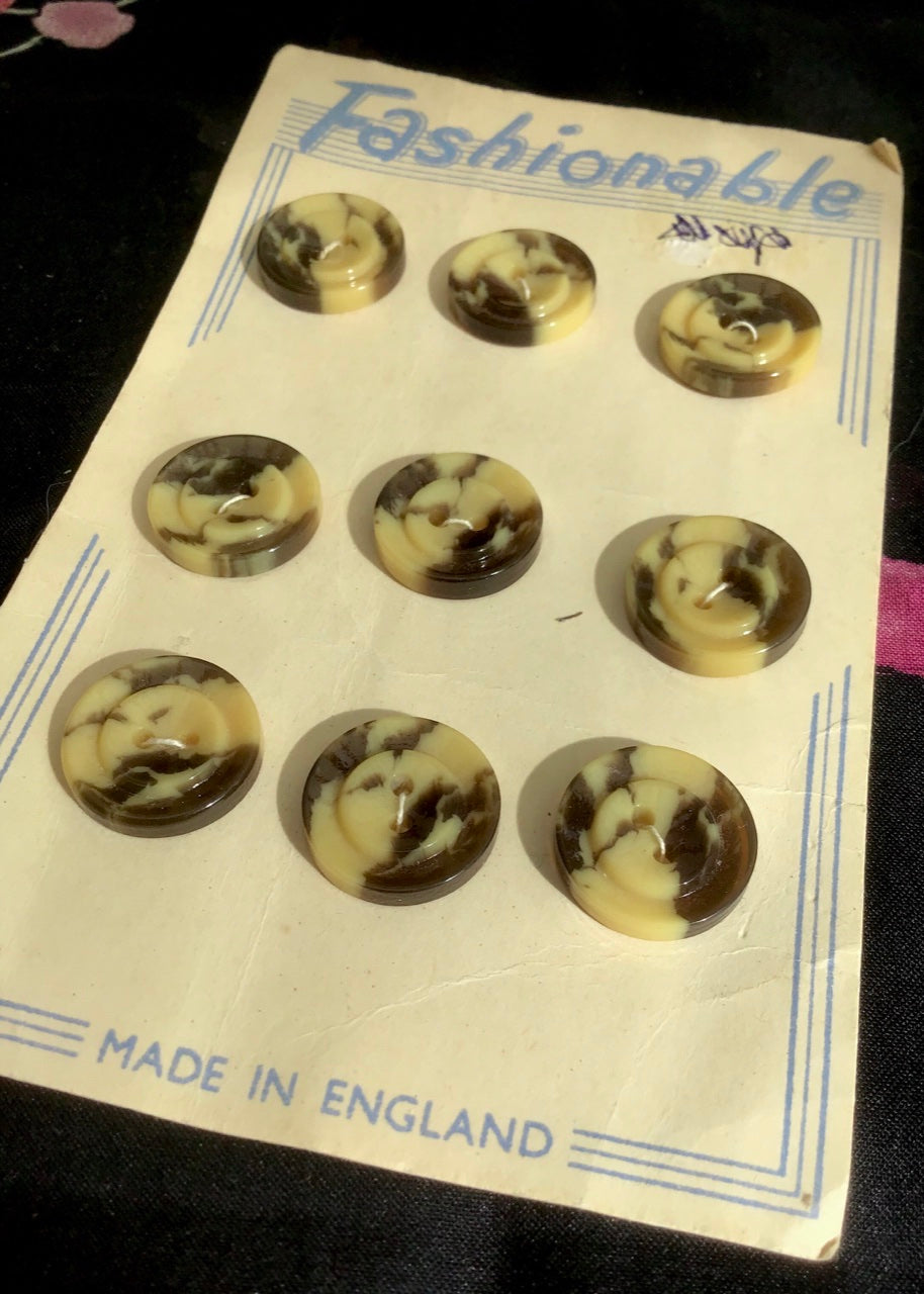 a vintage 40s Fashionable card of original small plastic buttons in a beige brow swirly faux tortoiseshell pattern, these are suitable for shirts and blouses.