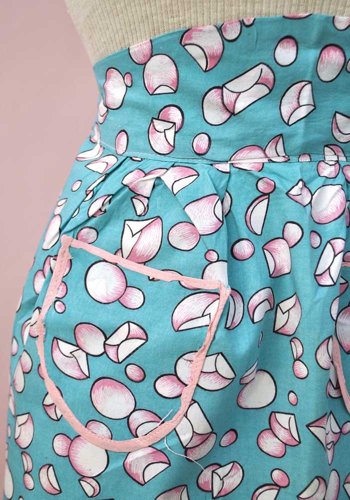 50s apron with a wide stiff waistband, patch pockets and frilly hem making a perfect hostess cover up.