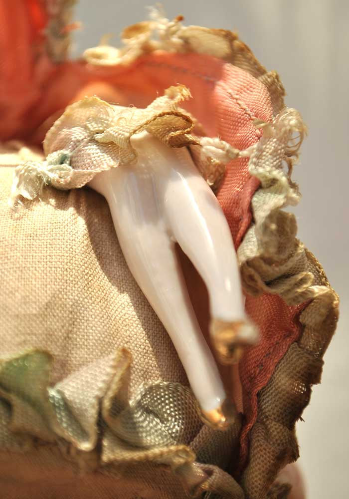 porcelain doll legs with gold shoes
