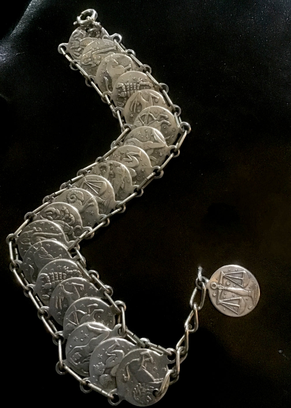 vintage zodiac coin bracelet, astrology symbols on coins linked together with a libra dangle pendant