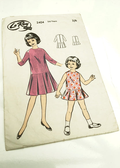 Vintage 1960s LeRoy #2404 sewing pattern for girl's pleated dress.