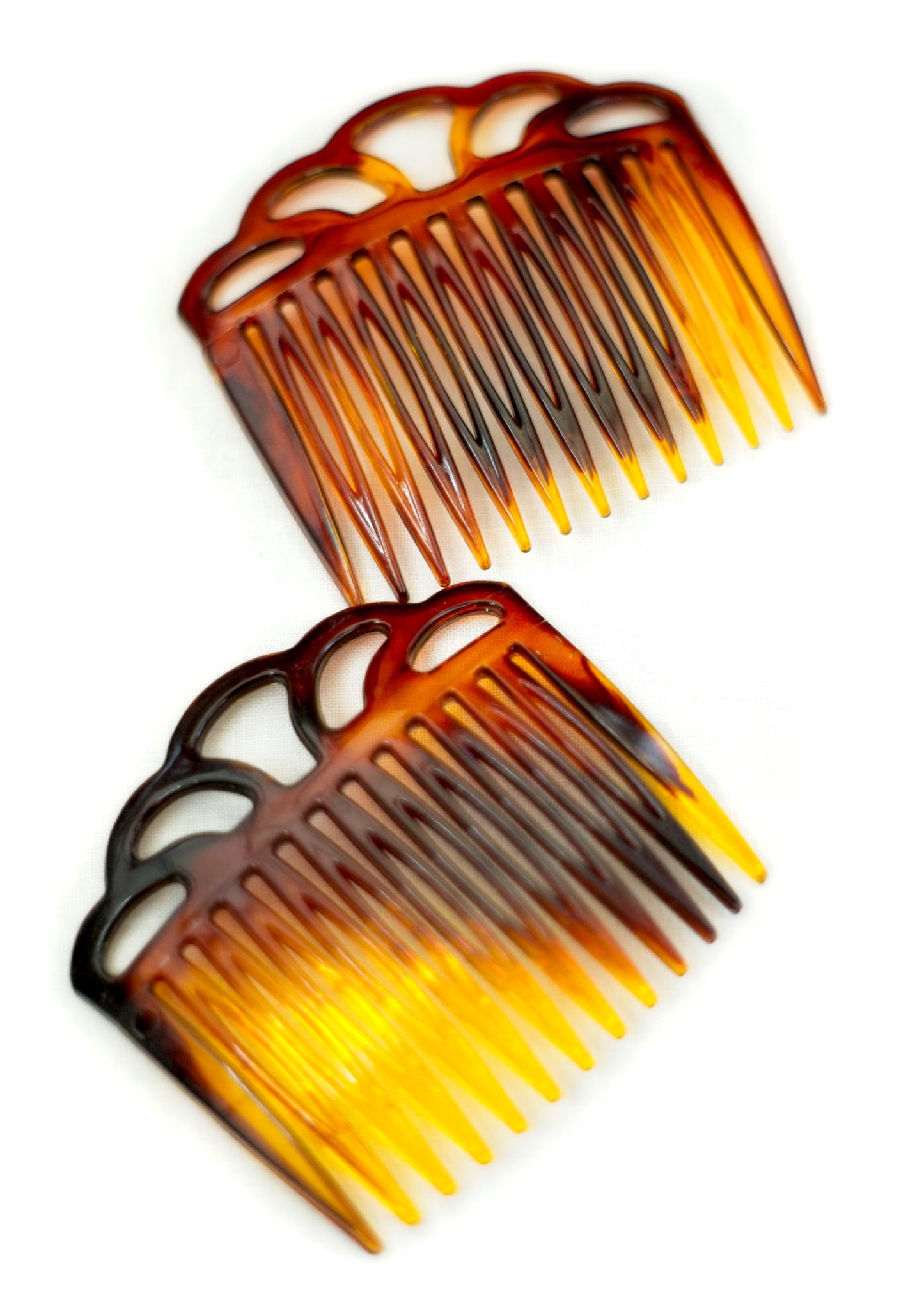 a pair of vintage celluloid hair combs