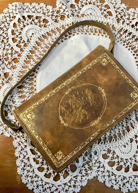 vintage tooled leather top handle purse wallet with gold embossed border pattern.