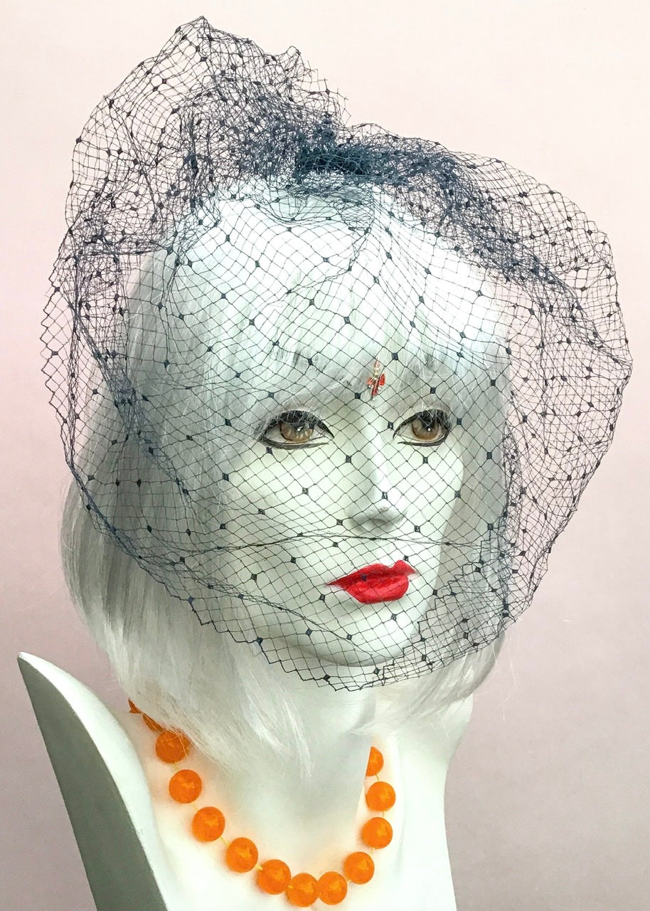 vintage fishnet hair netted veil, face covering in a dark blue wide net with spots.