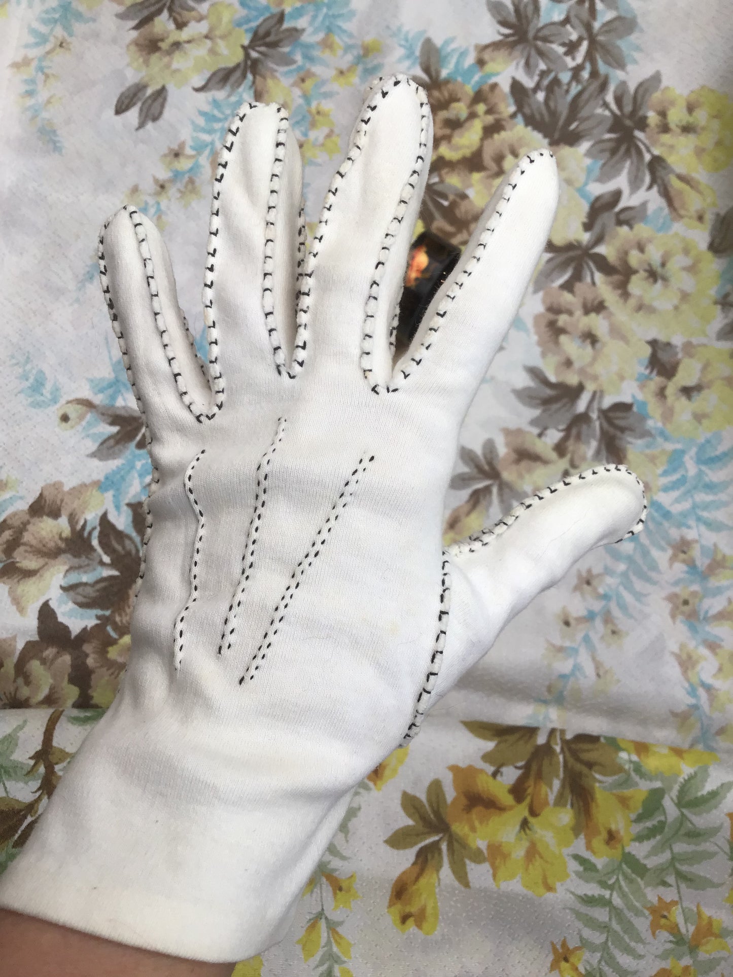 Vintage white cotton gloves, handmade with black contrasting stitching around the seams