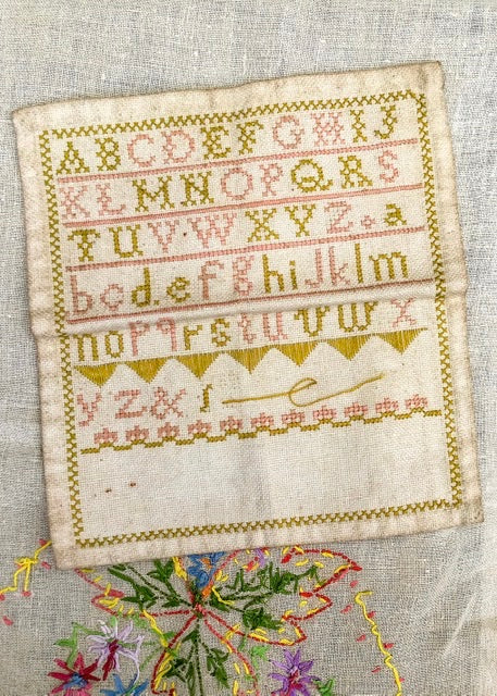 antique victorian alphabet sampler in pink and green silk thread.