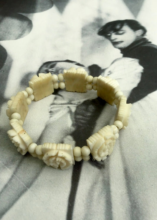 vintage 1930s carved ox bone bracelet, with tile beads strung with elastic.