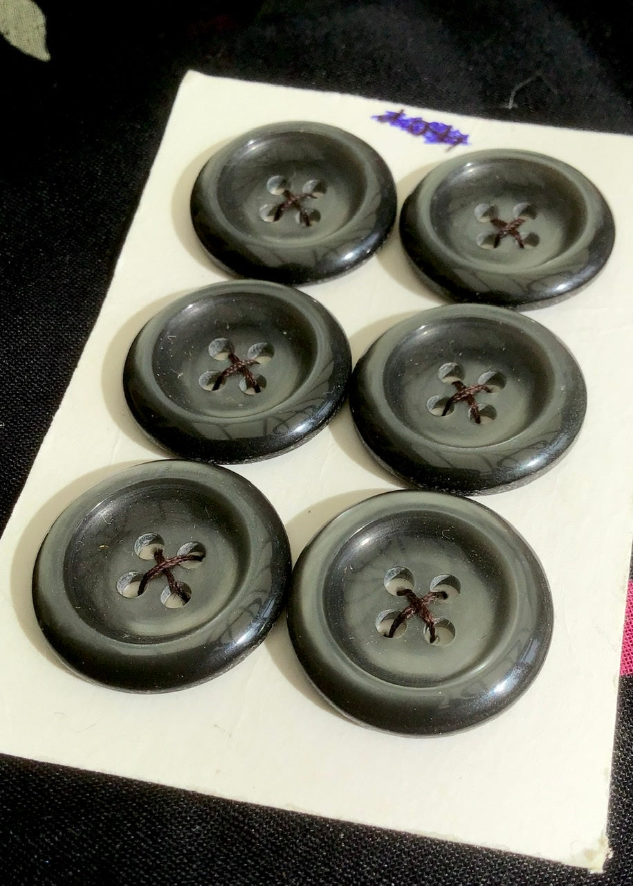 a set of six vintage grey buttons with four fastening holes and raised bevel edge, suitable for dresses, coats and cardigans