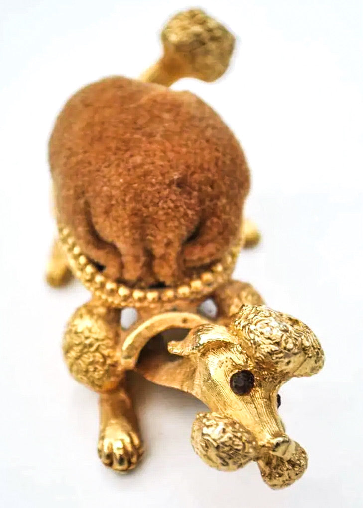 Vintage mirella poodle shaped pin cushion with moving head and wagging tail. Gold coloured metal with velvet body.